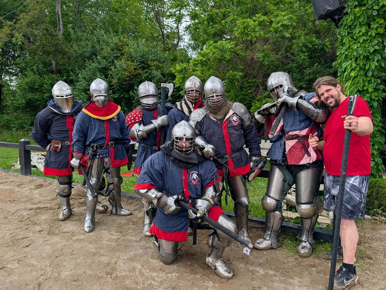 The team in armour, posed together on an outdoor list field
