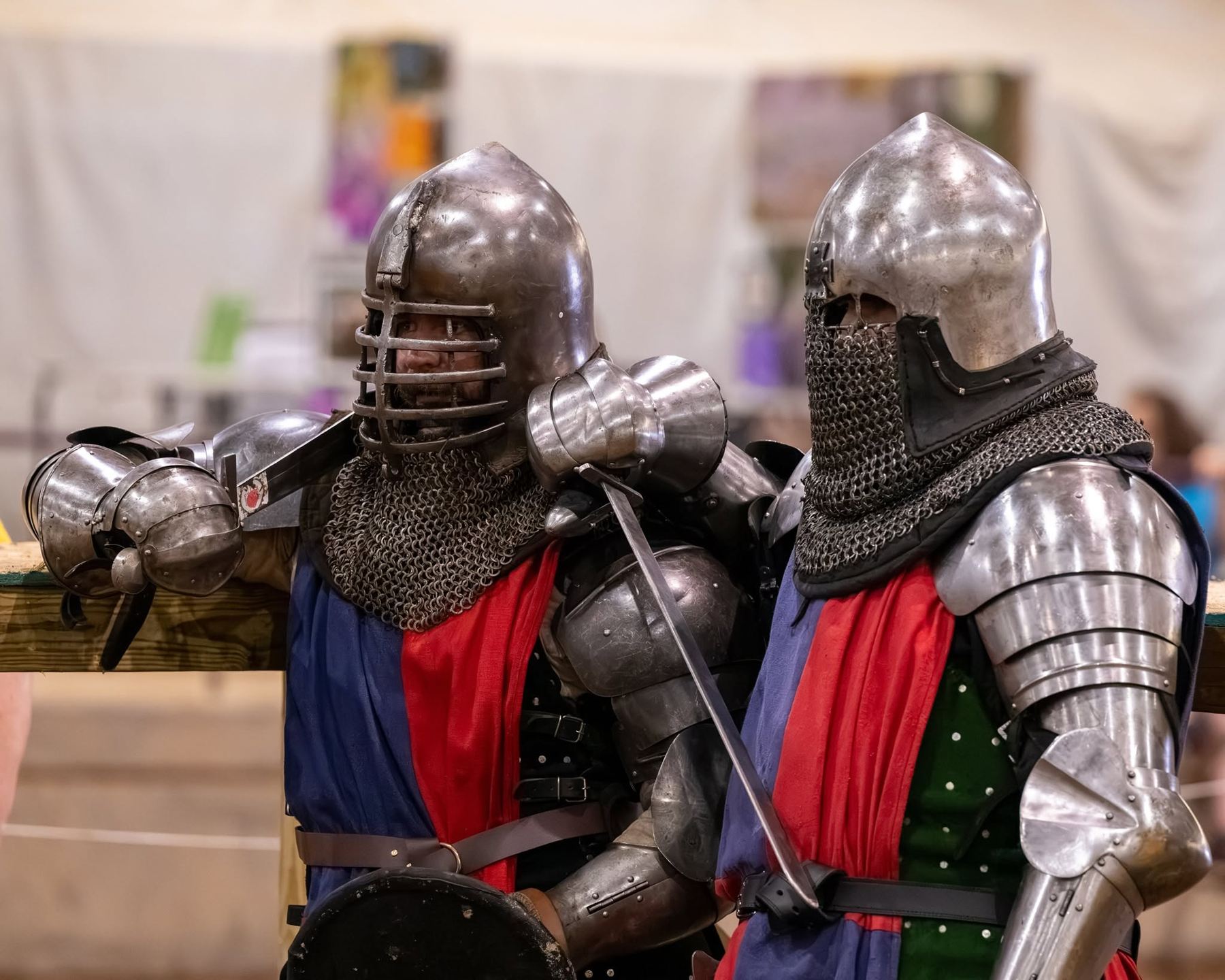 Two fighters in helms and mail waiting at the rail